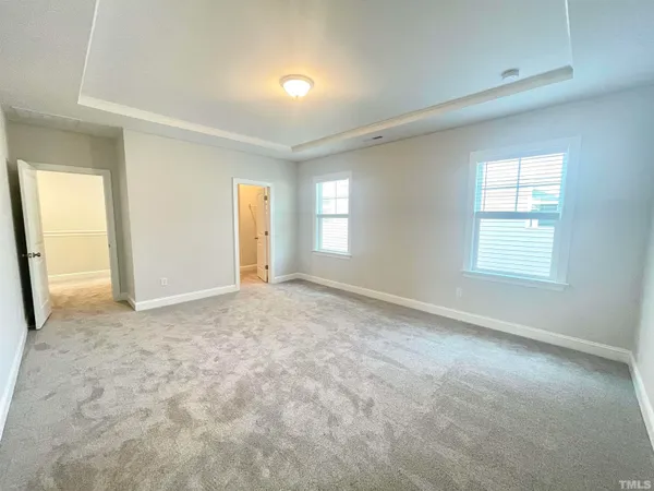 a spacious bathroom with a double vanity sink and mirror