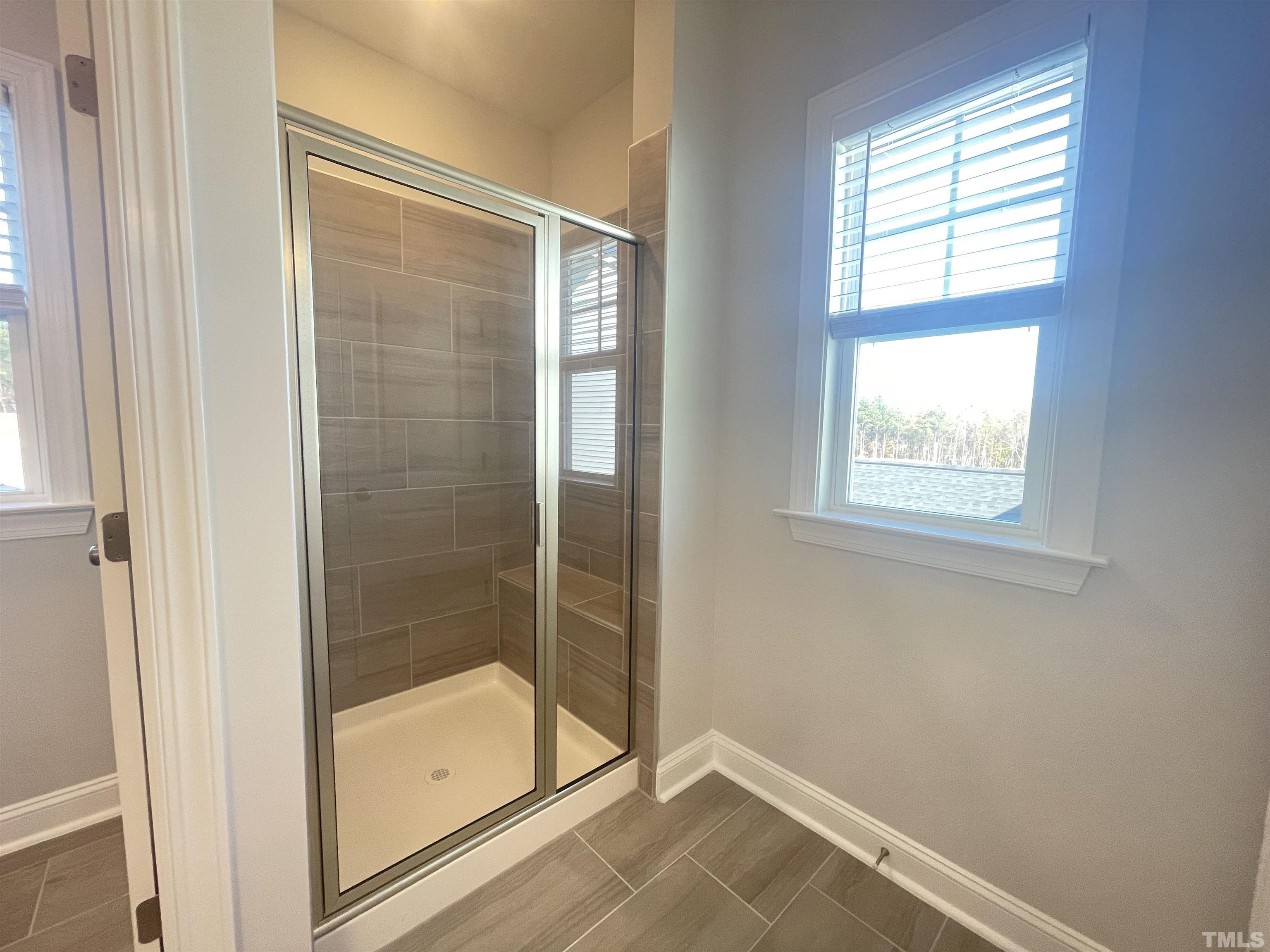 191 Edge Of Auburn Boulevard Raleigh, NC 27610 - Photo 15 of 24 a bathroom with a glass shower door