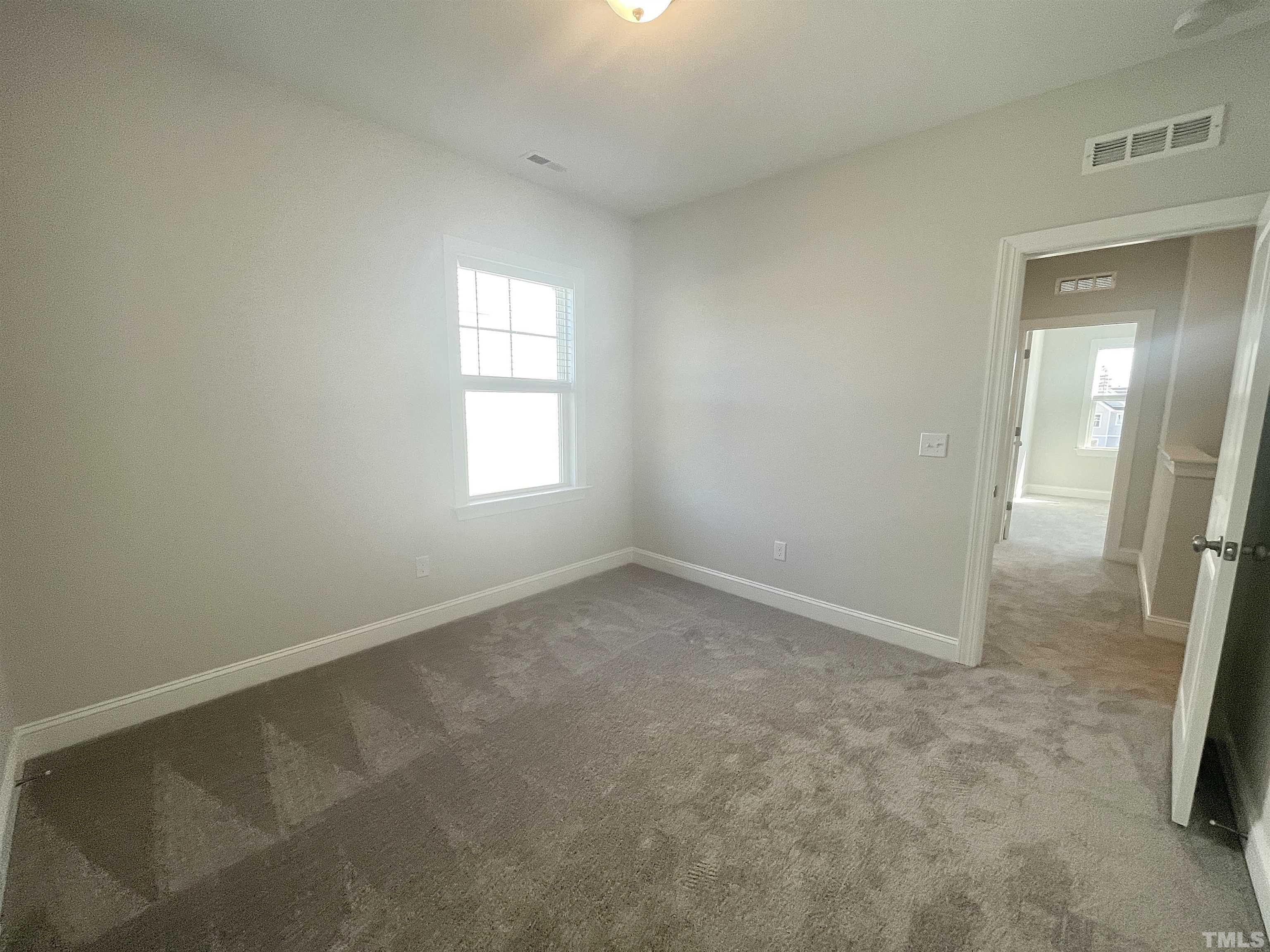 191 Edge Of Auburn Boulevard Raleigh, NC 27610 - Photo 18 of 24 an empty room with windows