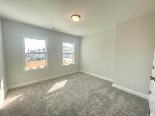 an empty room with a mirror