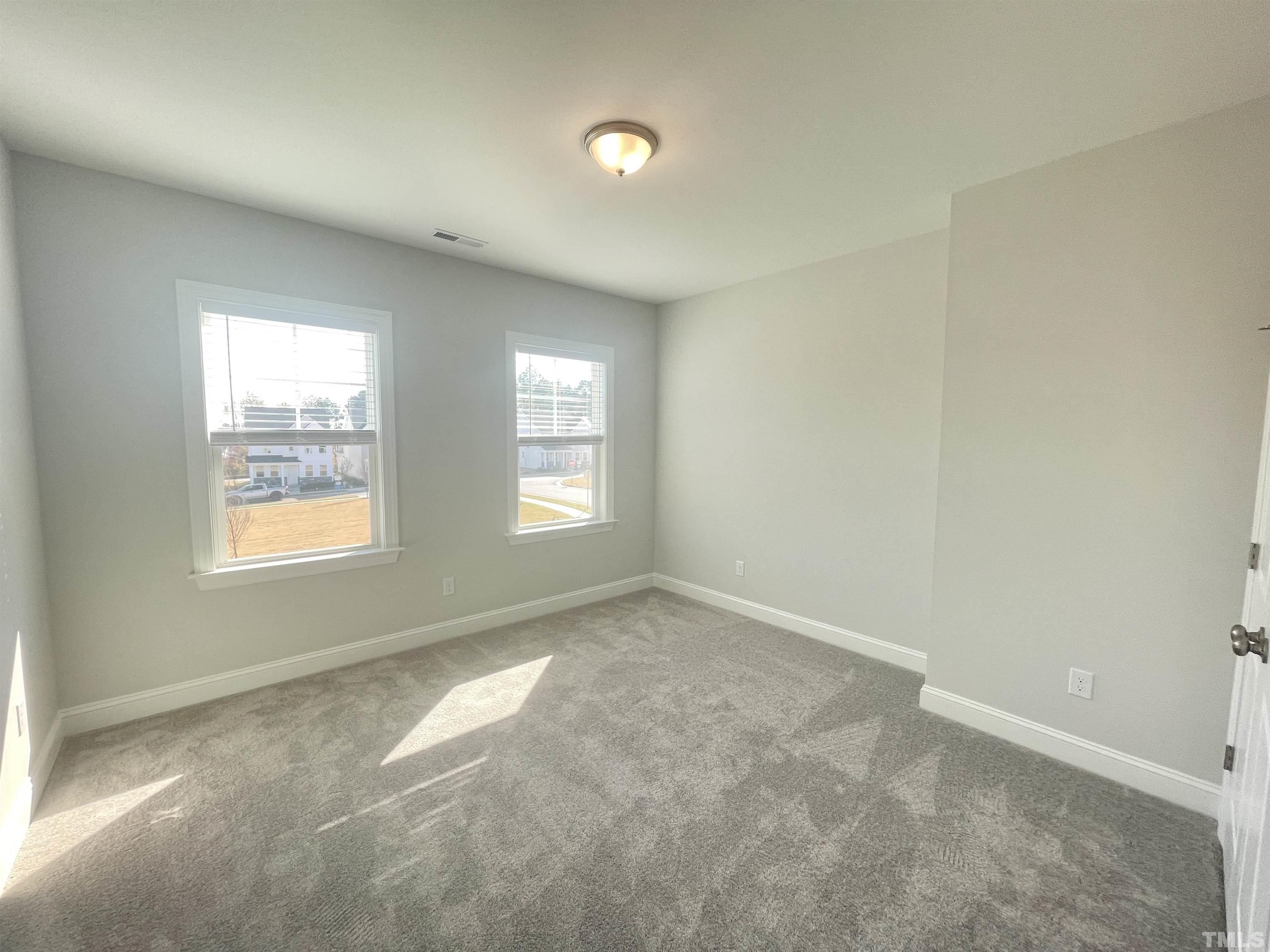 191 Edge Of Auburn Boulevard Raleigh, NC 27610 - Photo 19 of 24 an empty room with windows