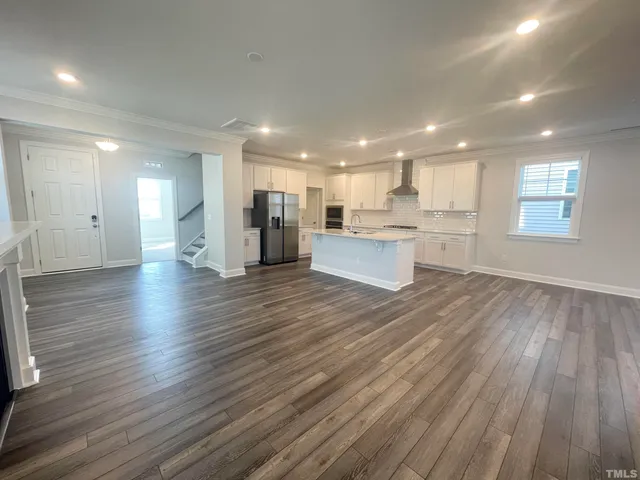 a view of kitchen with wooden floor and electronic appliances
