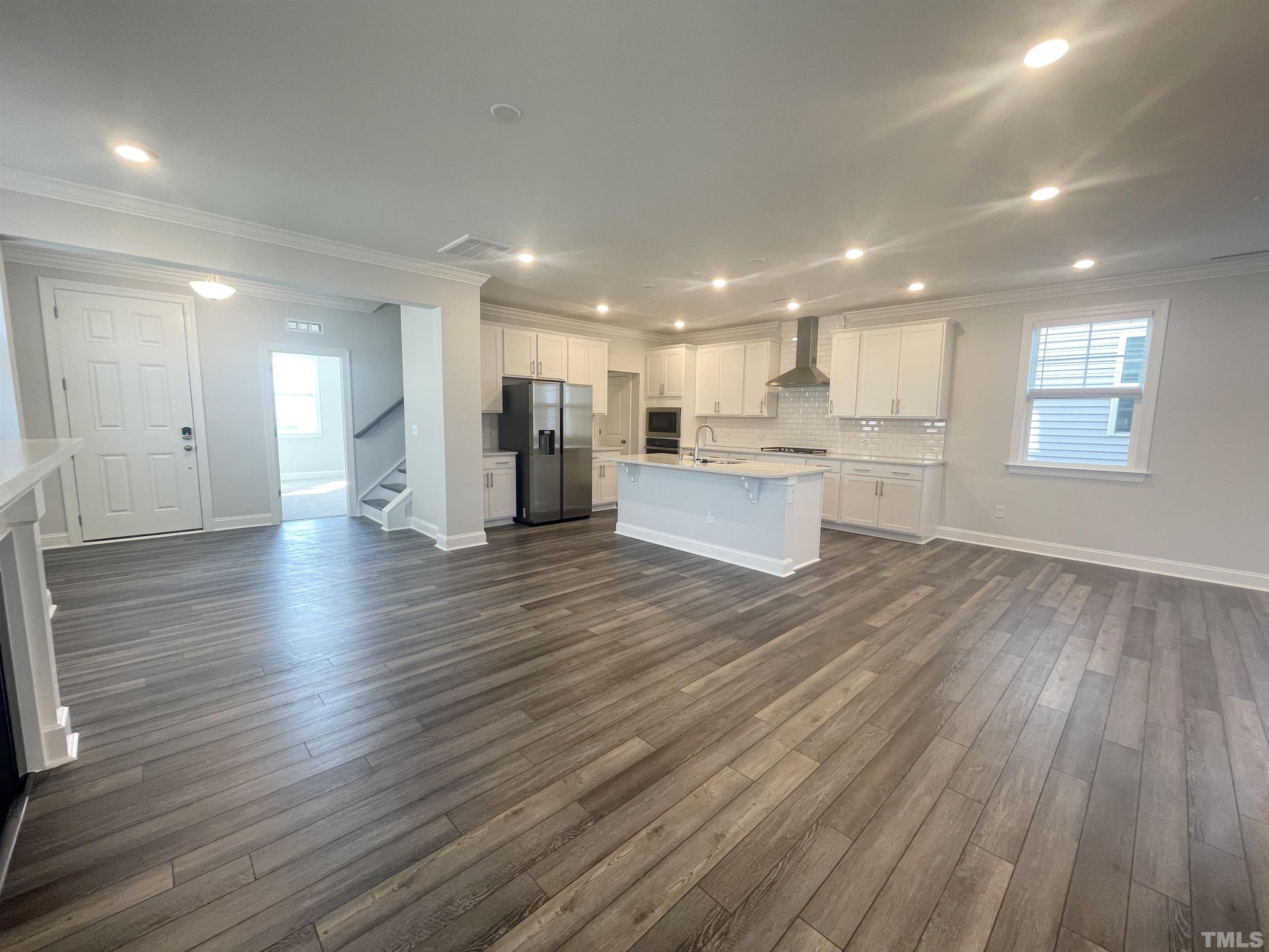 191 Edge Of Auburn Boulevard Raleigh, NC 27610 - Photo 3 of 24 a view of kitchen with wooden floor and electronic appliances