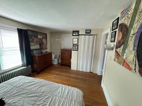 a bedroom with a large bed and a window