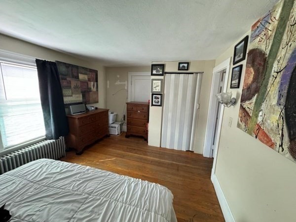 169 Main Street, Unit 1 Avon, MA 02322 - Photo 4 of 12 a bedroom with a large bed and a window