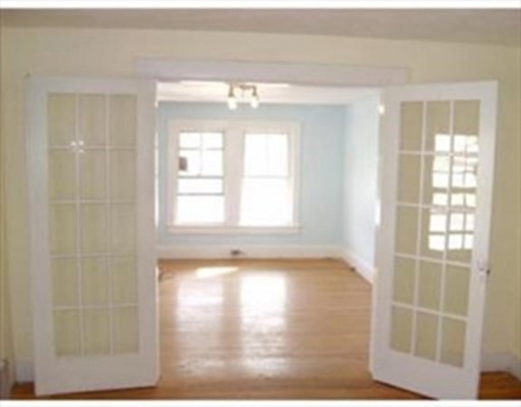 169 Main Street, Unit 1 Avon, MA 02322 - Photo 7 of 12 a view of an empty room with wooden floor and a window