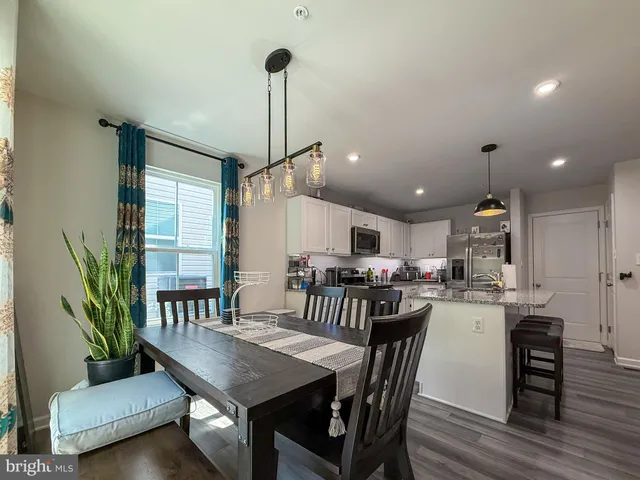 a kitchen with a table and chairs in it