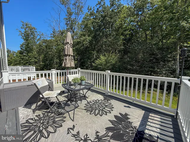 a view of a chairs and table on the deck