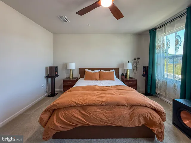 a bedroom with a bed and window