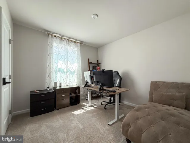 a livingroom with workspace and a window