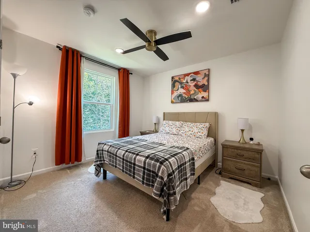 a bedroom with a bed and a ceiling fan
