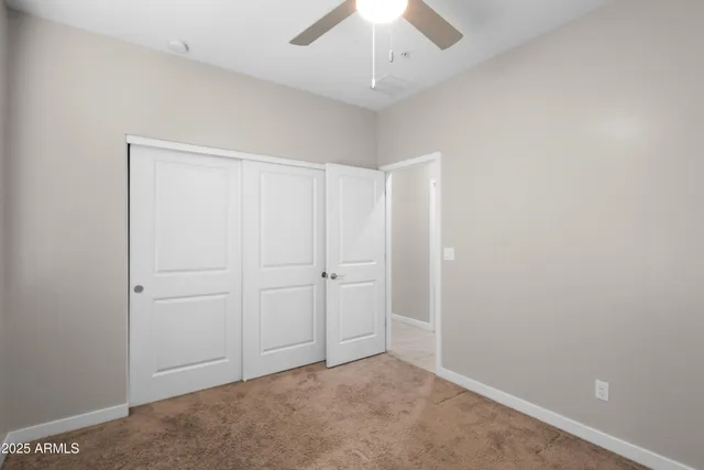 an empty room with a ceiling fan