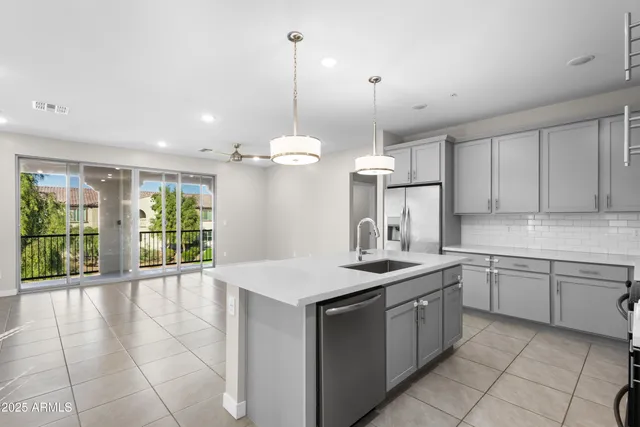 a kitchen with a sink a center island a stove cabinets and a counter top space