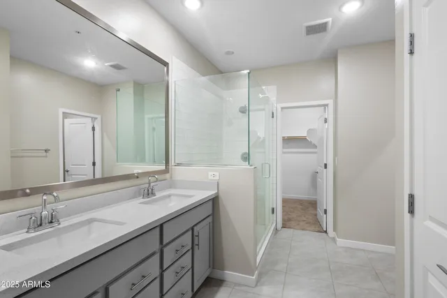 a spacious bathroom with a granite countertop sink mirror and double