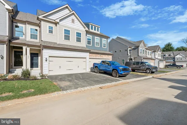 a car parked in front of a white house