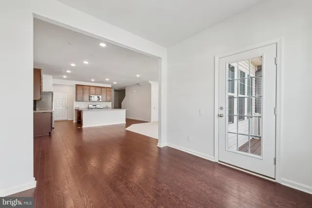 a view of kitchen and hall with wooden floor