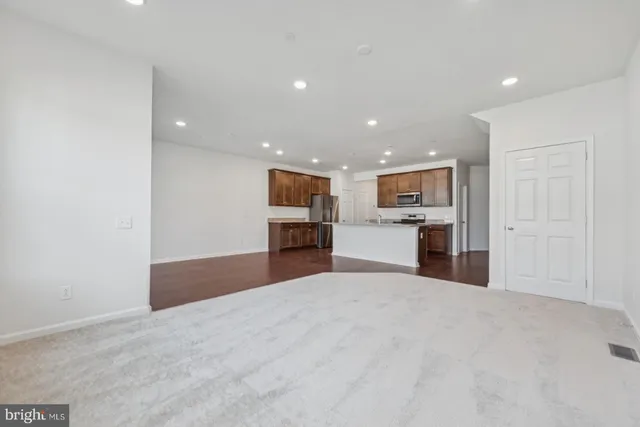 a view of kitchen with refrigerator and window