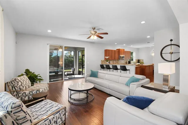 a living room with furniture a rug and white walls