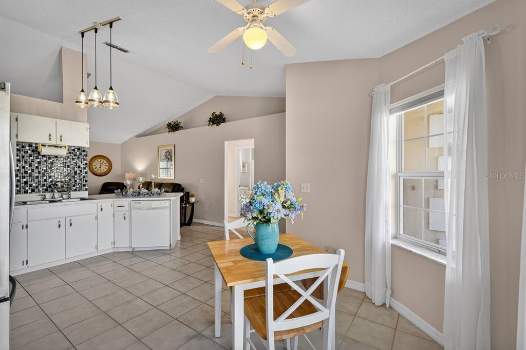 18 Smoke Tree Place Palm Coast, FL 32164 - Photo 12 of 34 a kitchen with white cabinets and chandelier