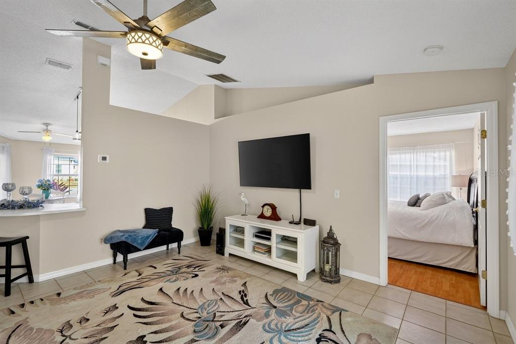 18 Smoke Tree Place Palm Coast, FL 32164 - Photo 17 of 34 a bedroom with furniture and a flat screen tv