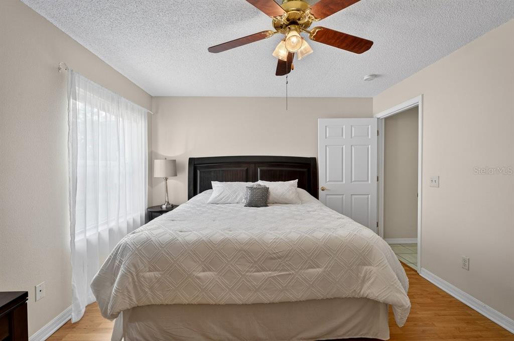 18 Smoke Tree Place Palm Coast, FL 32164 - Photo 18 of 34 a bedroom with a bed and a ceiling fan