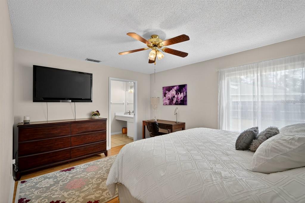 18 Smoke Tree Place Palm Coast, FL 32164 - Photo 19 of 34 a bedroom with a bed and a flat screen tv