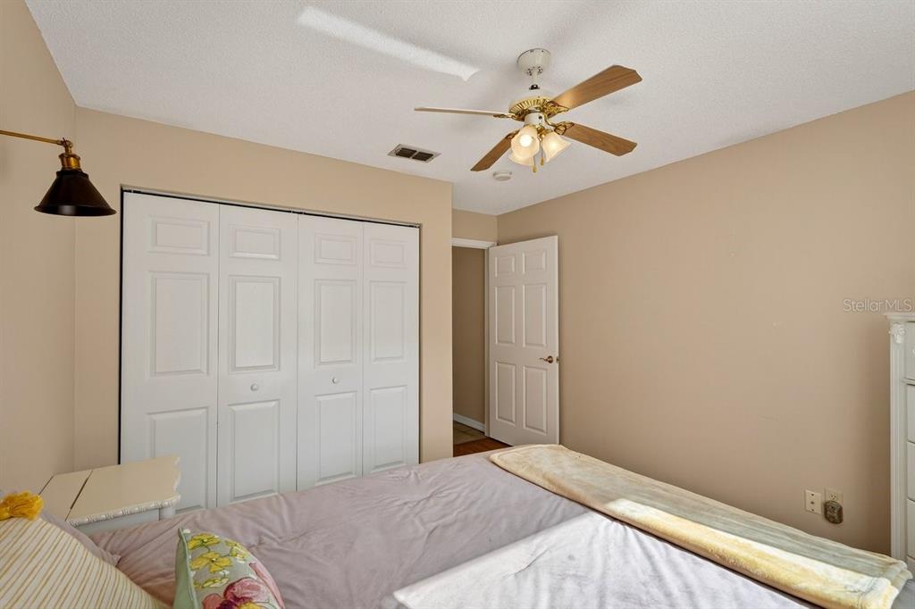 18 Smoke Tree Place Palm Coast, FL 32164 - Photo 29 of 34 a bedroom with a bed and a chandelier
