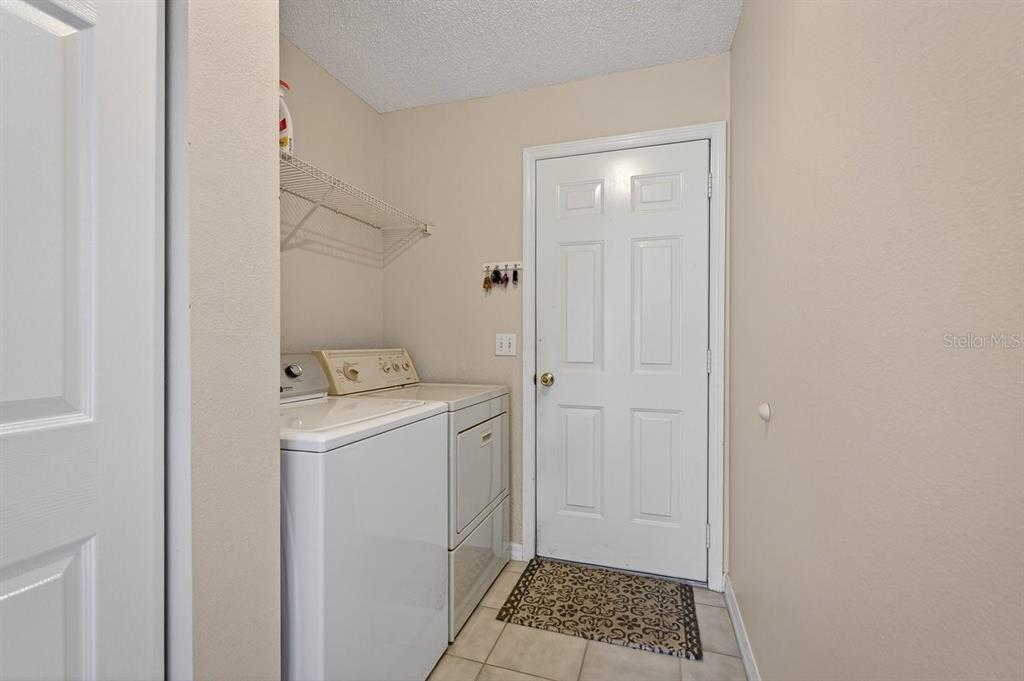 18 Smoke Tree Place Palm Coast, FL 32164 - Photo 30 of 34 a utility room with a window dryer and washer
