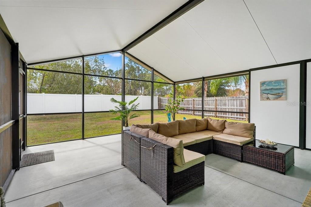 18 Smoke Tree Place Palm Coast, FL 32164 - Photo 31 of 34 a living room with furniture and a floor to ceiling window