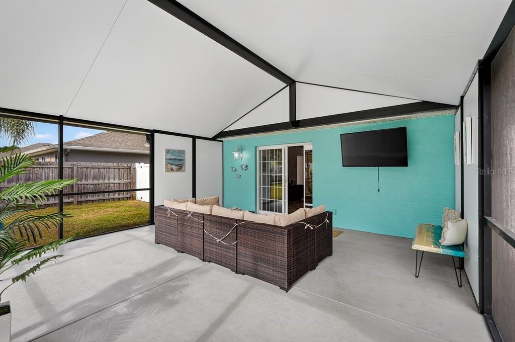 18 Smoke Tree Place Palm Coast, FL 32164 - Photo 32 of 34 a bedroom with furniture and a flat screen tv