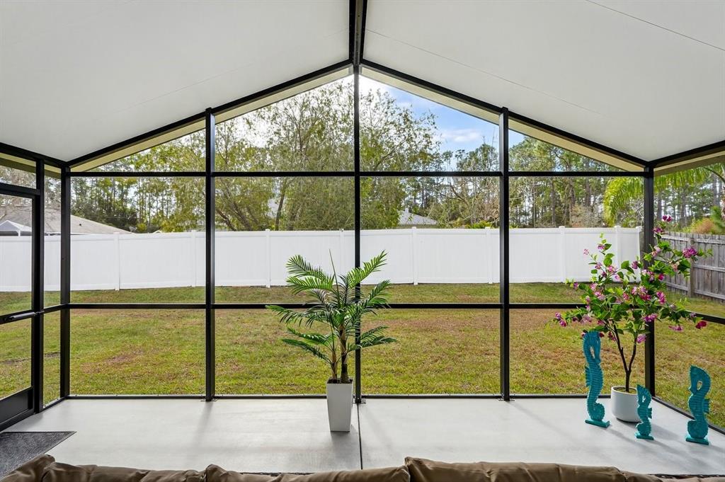 18 Smoke Tree Place Palm Coast, FL 32164 - Photo 33 of 34 a view of a porch with a floor to ceiling windows