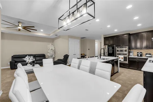 a living room with furniture a rug and a chandelier