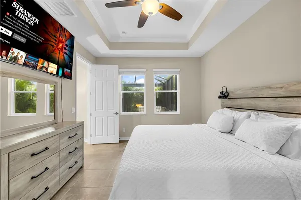 a bedroom with a bed and a flat screen tv