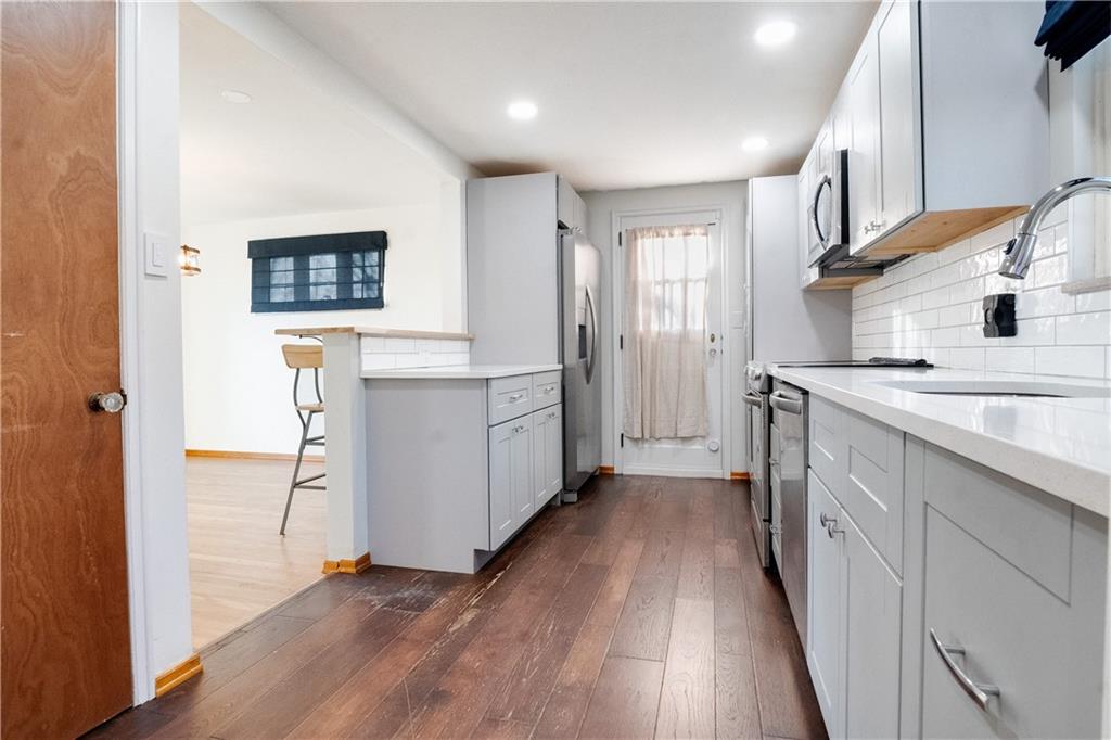 406 Bower Hill Road Pittsburgh, PA 15228 - Photo 12 of 26 a view of a kitchen cabinets a sink and wooden floor