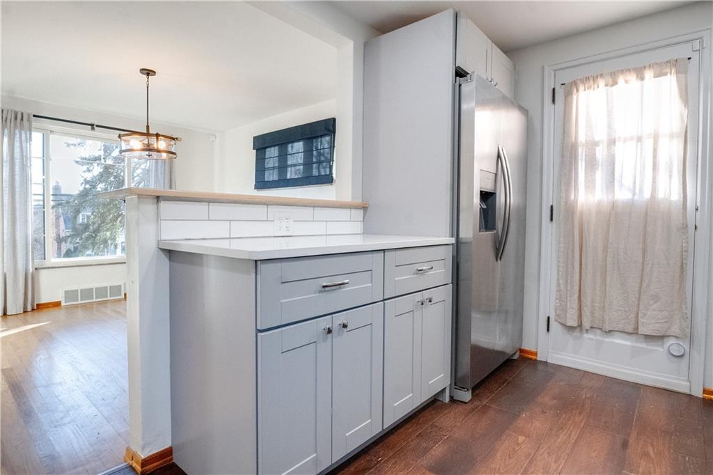 406 Bower Hill Road Pittsburgh, PA 15228 - Photo 15 of 26 a kitchen with white cabinets and wooden floor