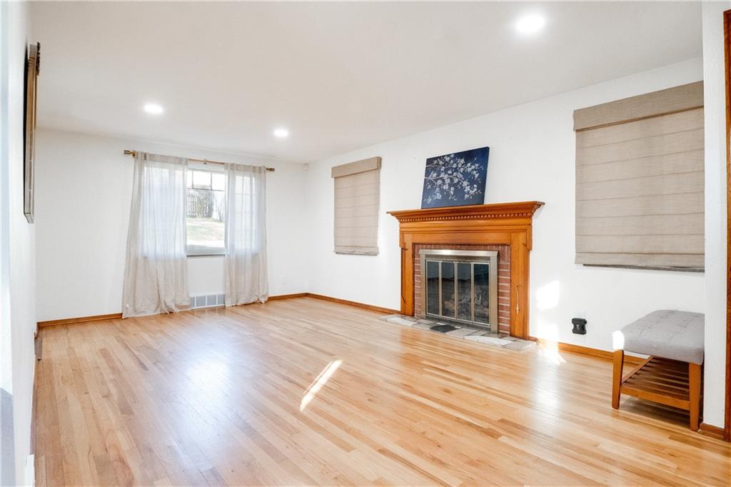 406 Bower Hill Road Pittsburgh, PA 15228 - Photo 6 of 26 a view of a livingroom with wooden floor and a fireplace