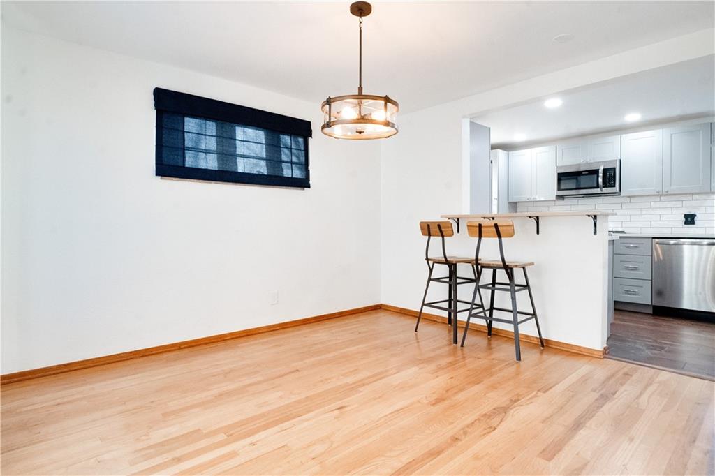 406 Bower Hill Road Pittsburgh, PA 15228 - Photo 9 of 26 a view of a dining room with furniture wooden floor and chandelier