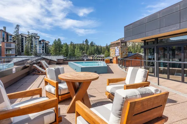 a view of a patio with swimming pool table and chairs