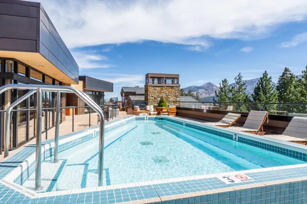 a swimming pool with outdoor seating