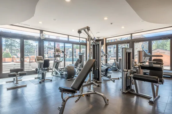 a view of a room with gym equipment and floor to ceiling window