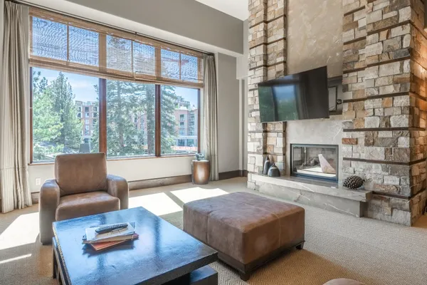 a living room with furniture a flat screen tv and a fireplace