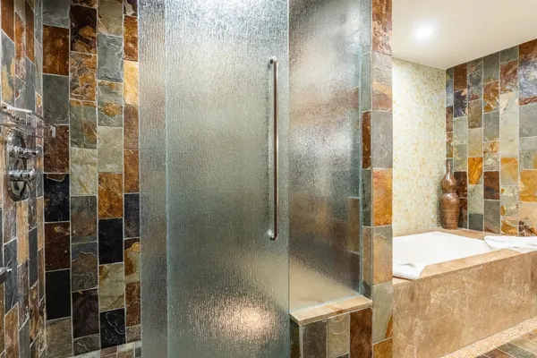 a bathroom with a shower and a sink