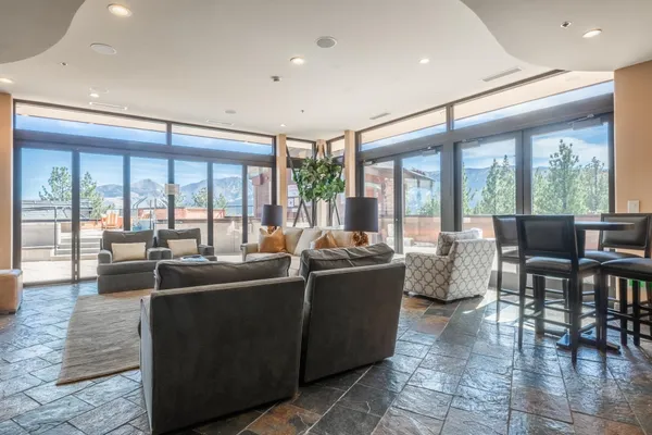 a living room with furniture and large windows