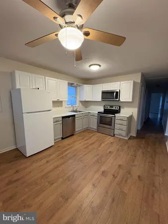 a kitchen with stainless steel appliances granite countertop a refrigerator a stove a microwave oven a sink with island and chairs