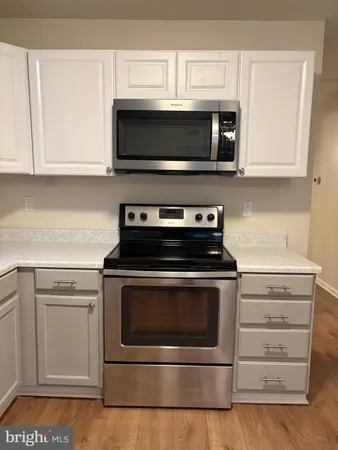 a kitchen with stainless steel appliances granite countertop a stove microwave and oven
