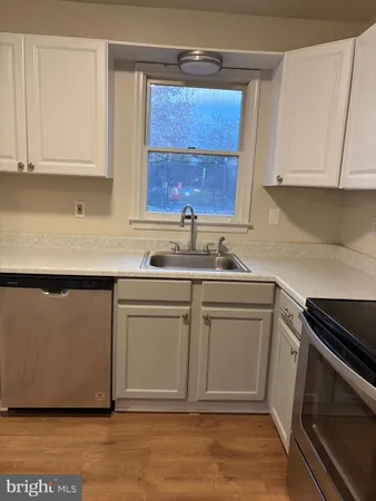 a kitchen with white cabinets and a sink