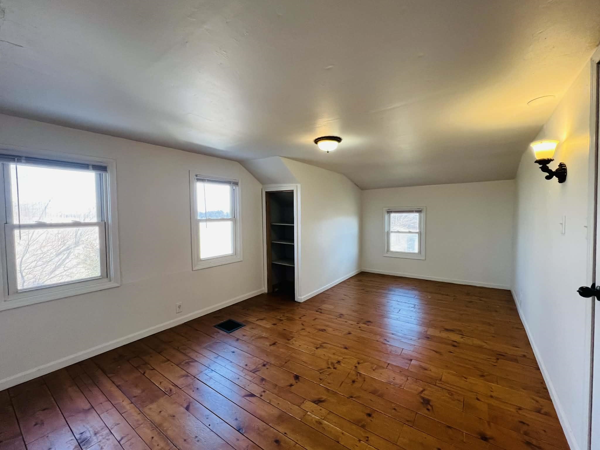 1625 South County Divide Road Pearl City, IL 61062 - Photo 21 of 30 an empty room with wooden floor and windows