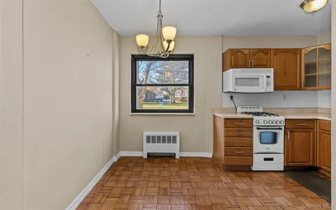 a view of kitchen with stainless steel appliances granite countertop a stove a sink and a microwave