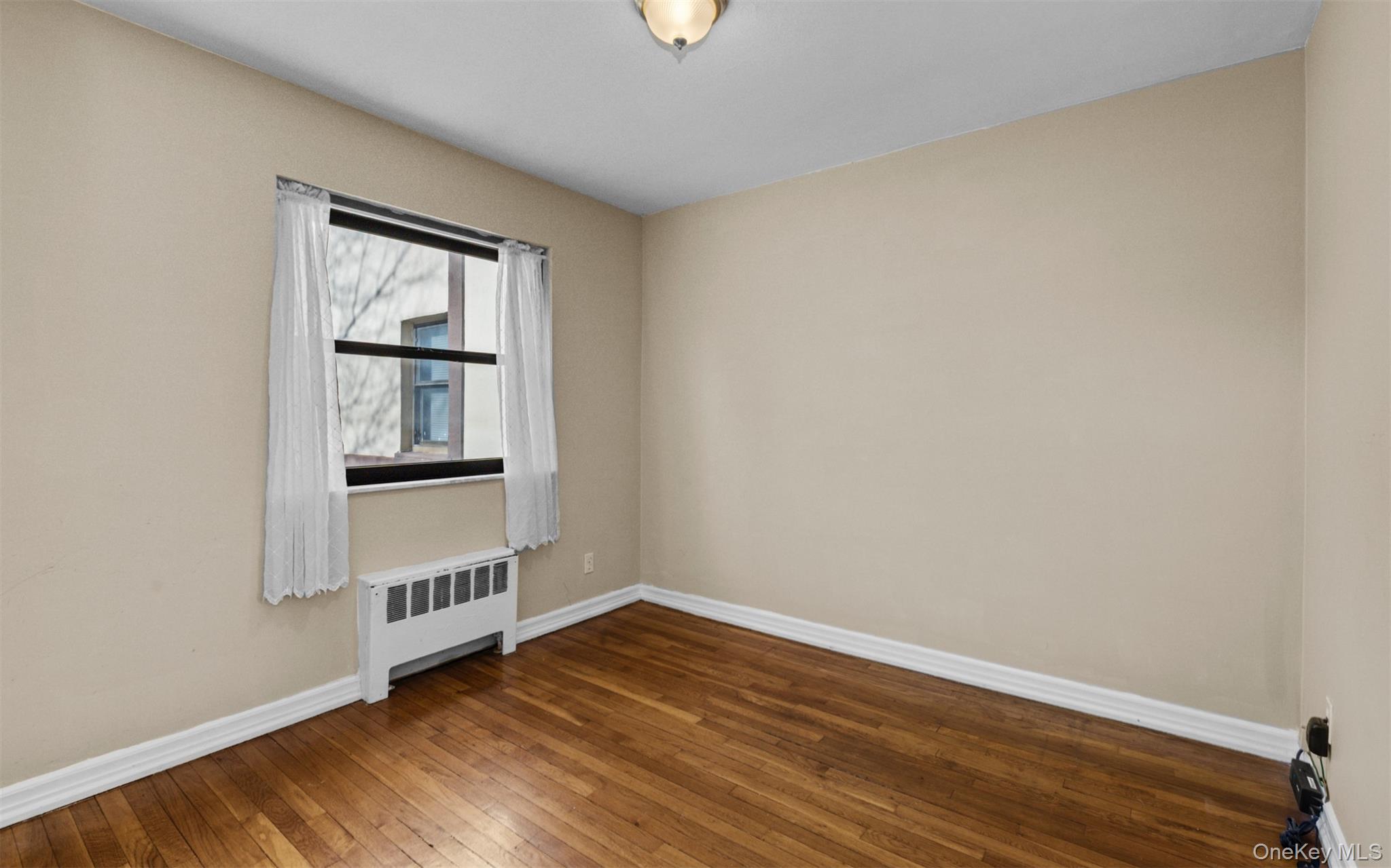113 15th Street, Unit 1C Garden City, NY 11530 - Photo 10 of 14 a view of wooden floor and windows in a room
