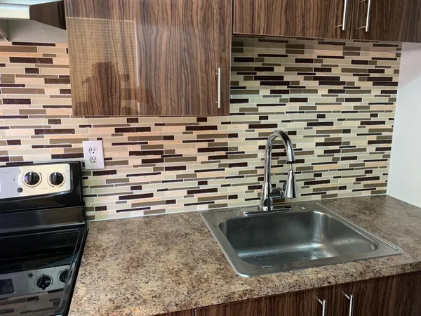 a kitchen with a sink and a stove